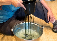 Aerating woad liquid by draining through plant pot | woad.org.uk